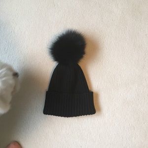 Black hat with a fur puff